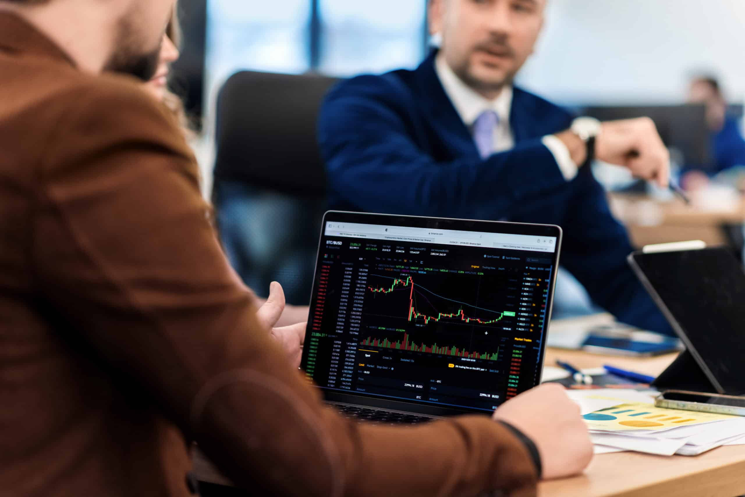 Business meeting in an office, workers discussing business affairs. Gadgets and papers with charts on the table